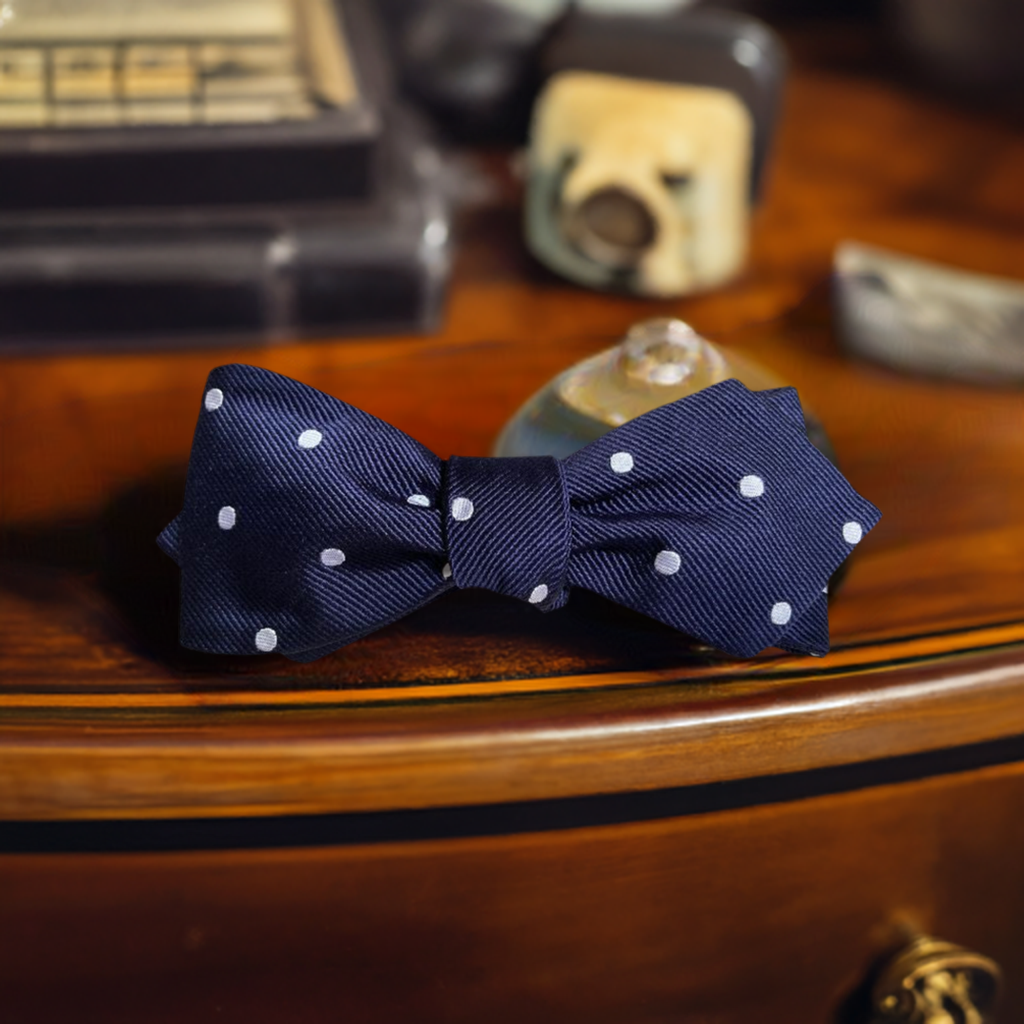 The Churchill navy blue and white polka dot self tie bow tie 
